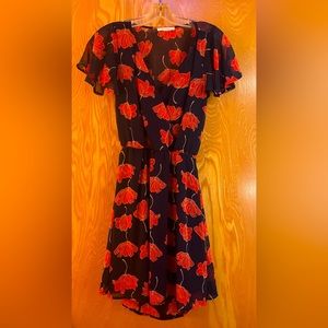 Black Bead backless floral navy and red dress with ruffled cap sleeves.